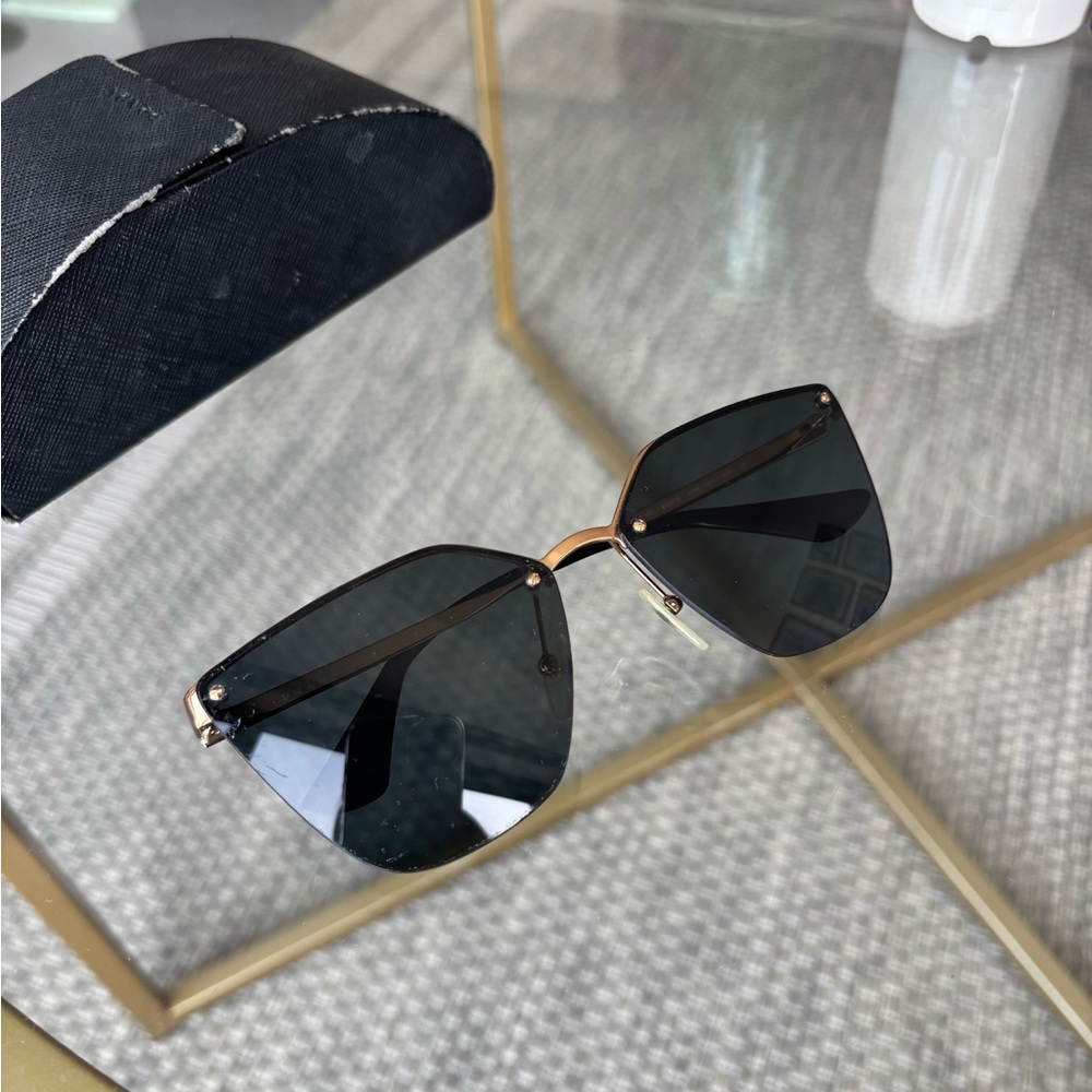 Prada Black Cat-Eye Glasses with Rimless Design